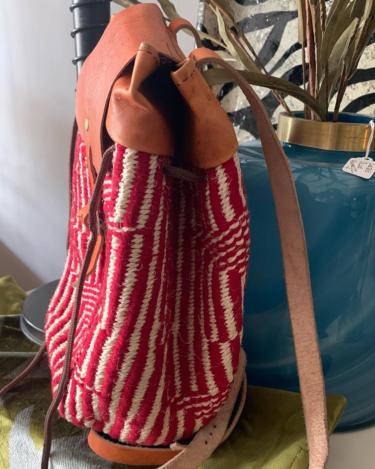 A red kilim bag with leather straps