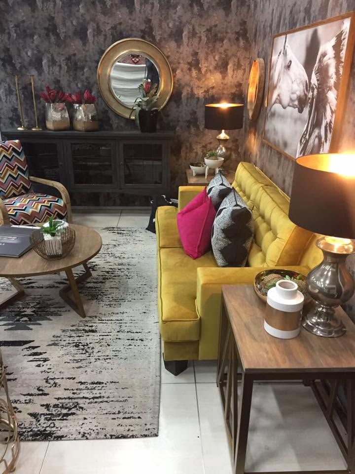 The mustard sofa with pink and black cushions