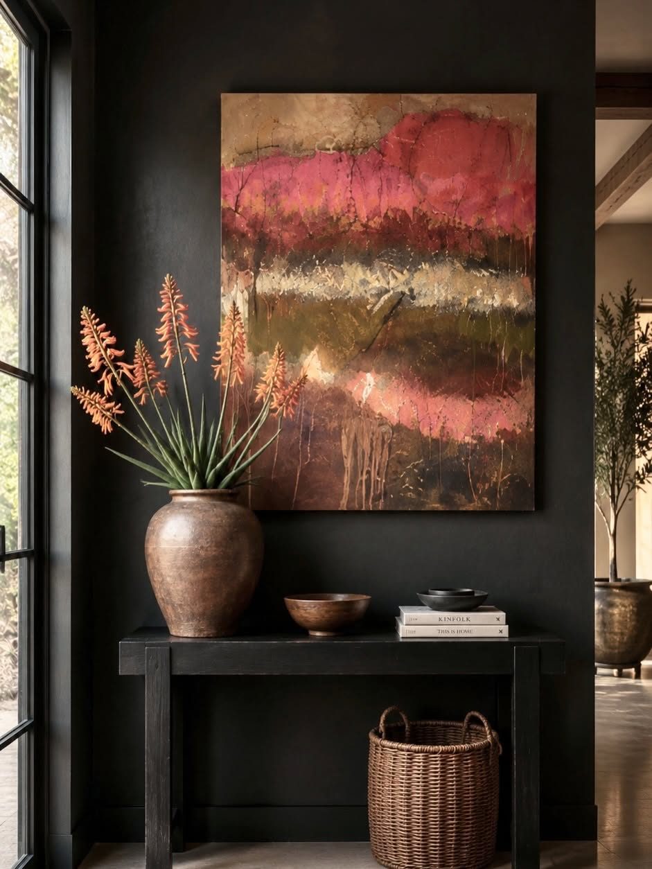 Fynbos in Dusk hanging above a dark console with a clay vase