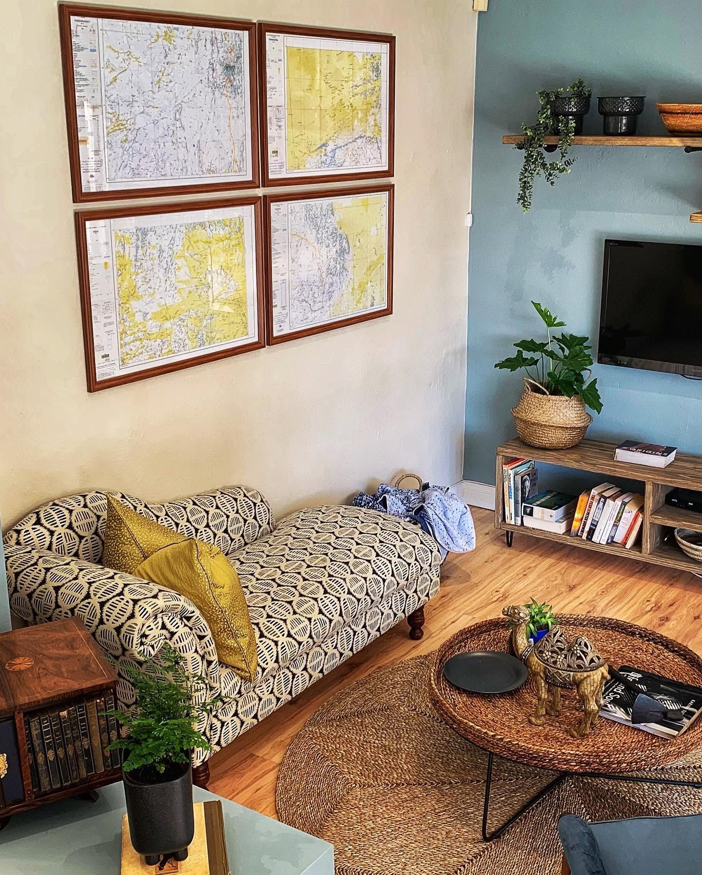 The chaise below framed maps