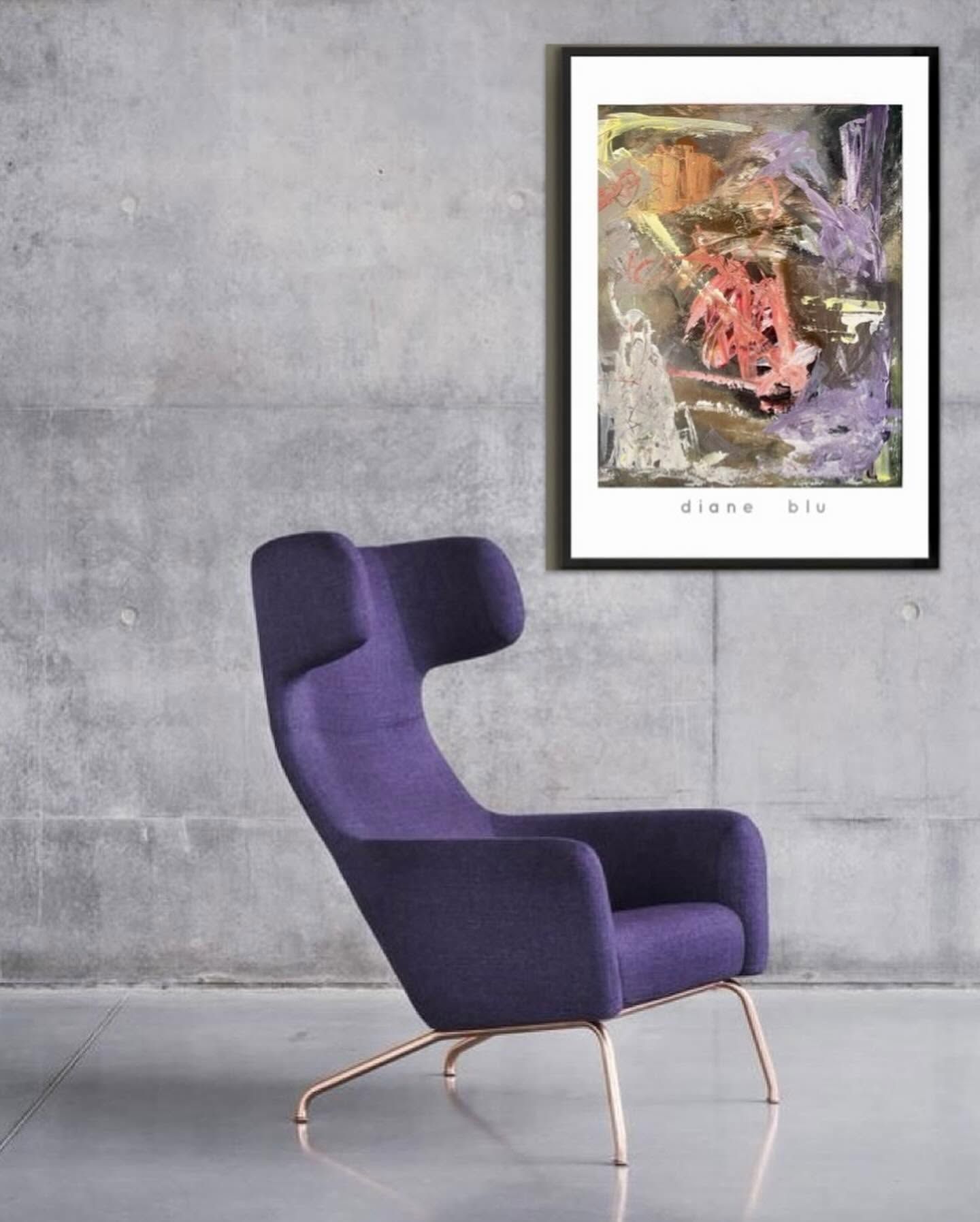 A framed painting beside a purple wingback chair
