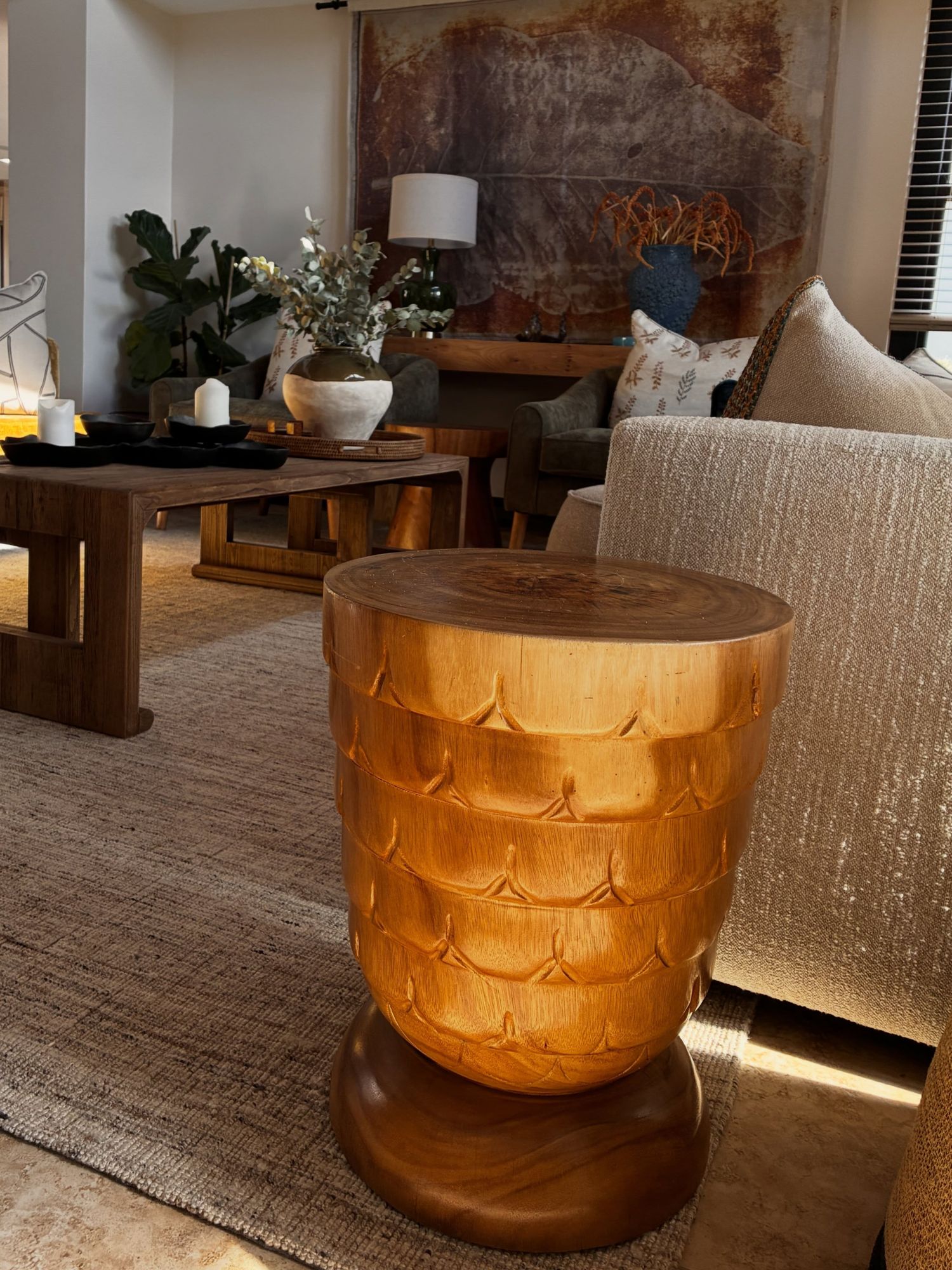 A carved copper-toned side table
